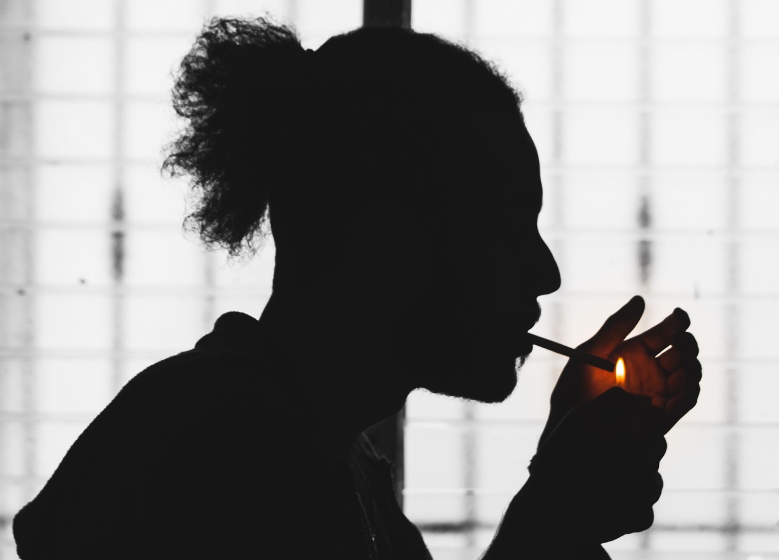 guy smoking in the shadows